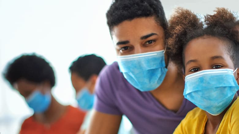 Father and daughter wearing masks