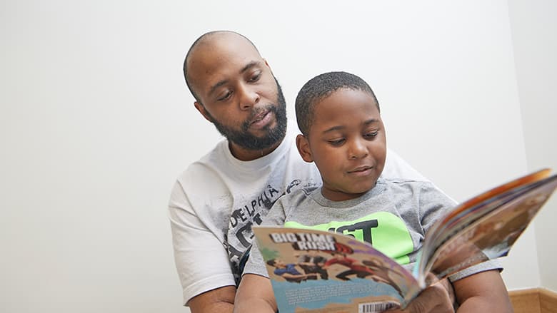 Father reading with son Father reading with son