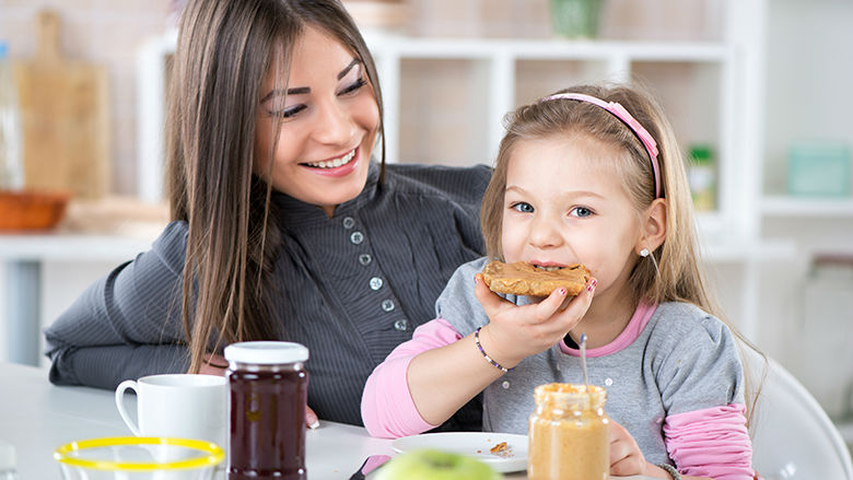 Girl eating bread with peanut butter