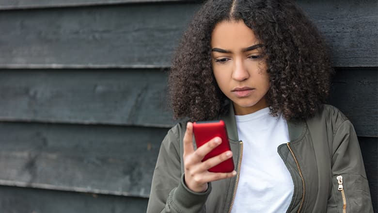 Teen girl looking at her smartphone