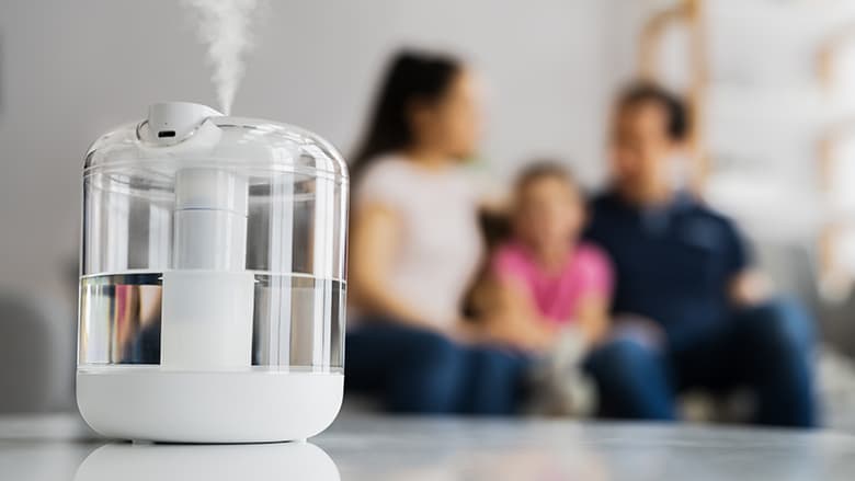Closeup of humidifier with family in background