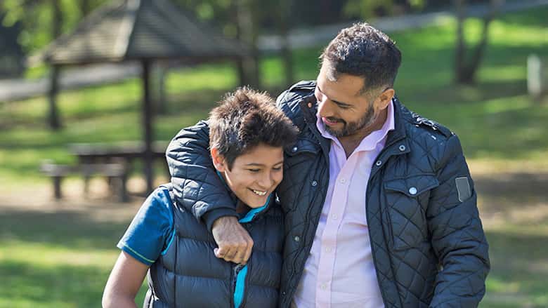 Father and son walking outside together