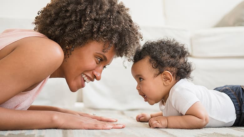 Mother playing with young toddler on the floor