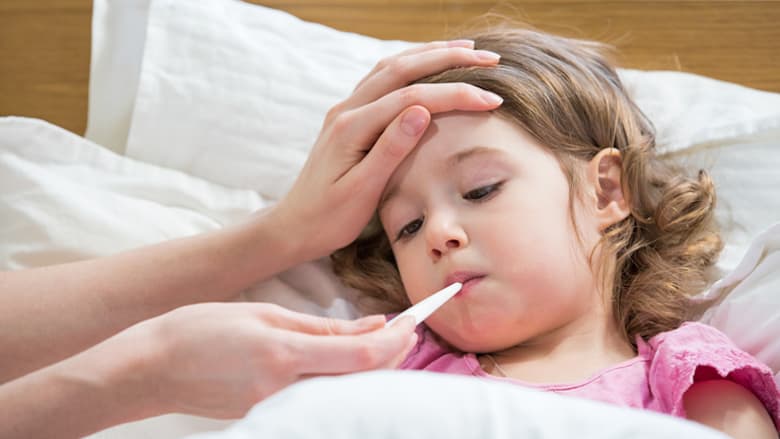 Girl getting temperature taken