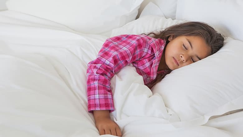 Young girl sleeping in bed