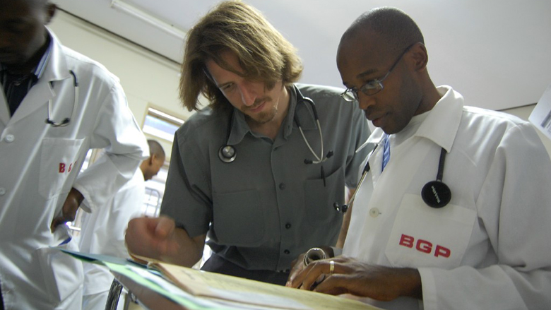 Henry Welch looking at charts with team in Botswana