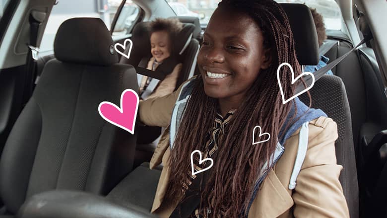 Mom and child smiling in a car