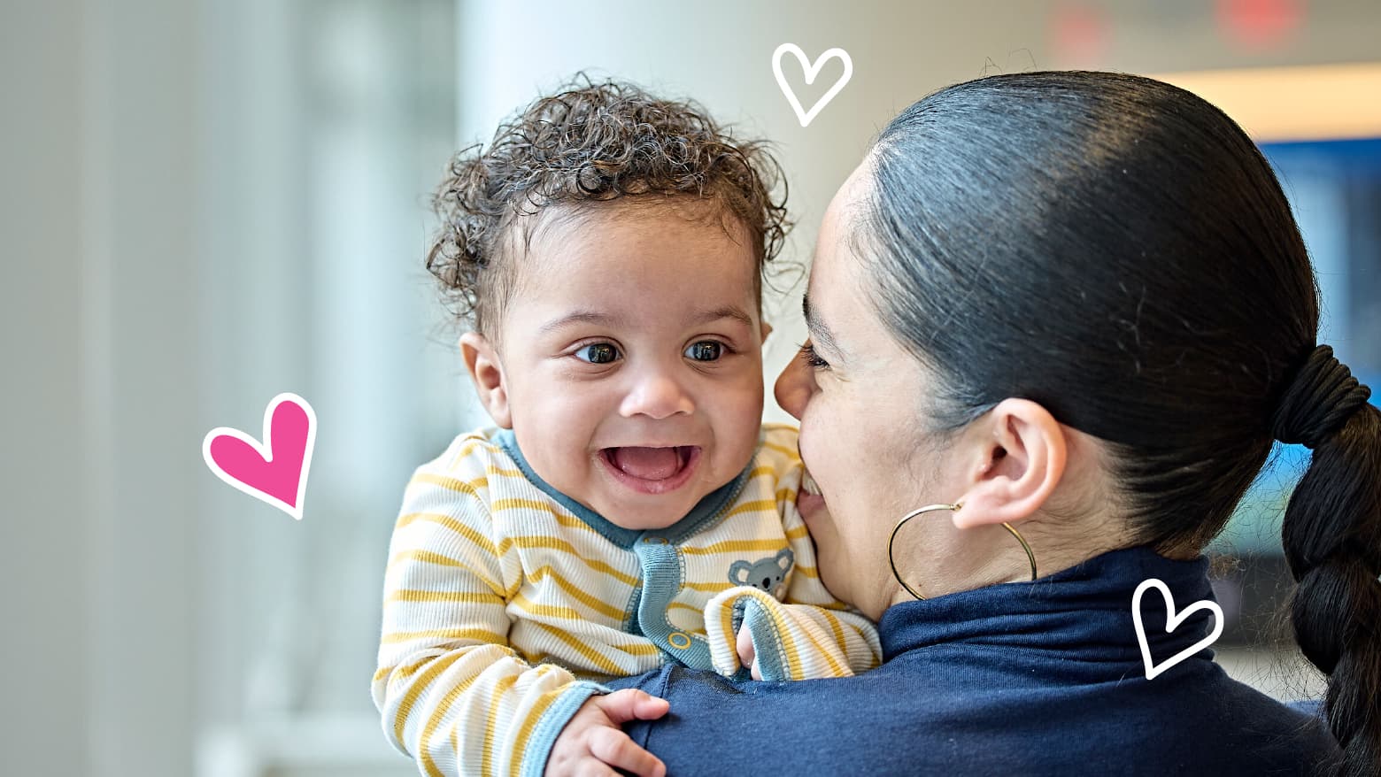 Smiling infant and their mom