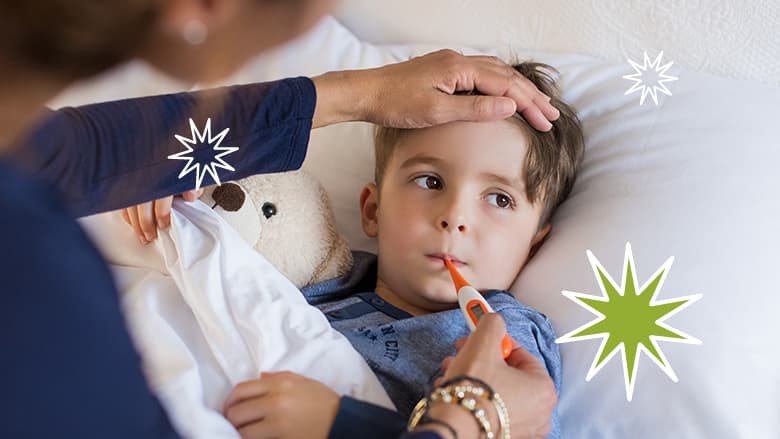 Boy in bed having temperature taken Boy in bed having temperature taken