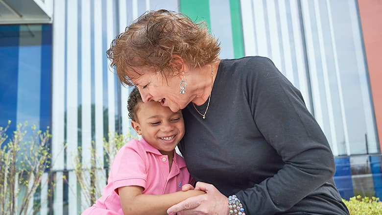 Grandmother hugging grandson