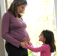 Little girl with pregnant mom