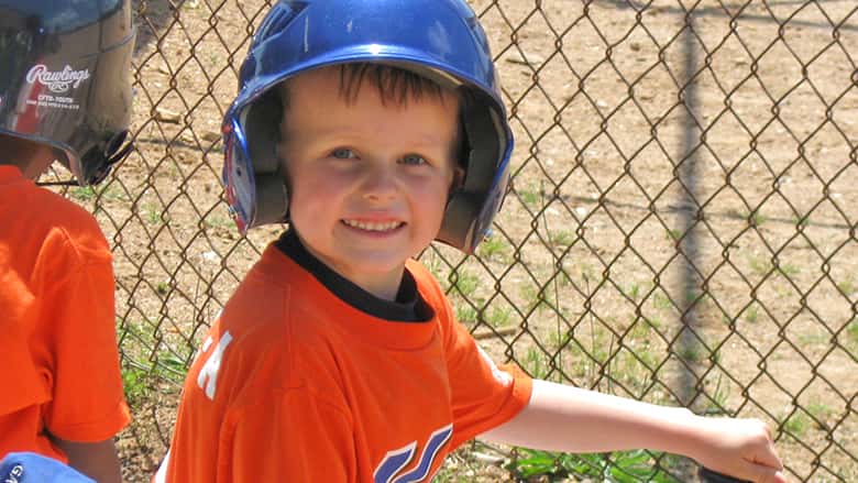 Evan in his baseball uniform