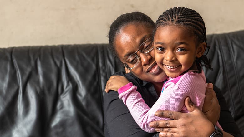 Mother hugging daughter