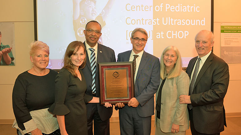 Radiologist group holding plaque