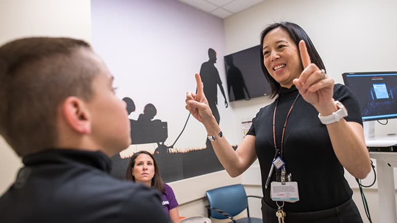 Doctor conducting eye test for concussion symptoms Doctor conducting eye test for concussion symptoms