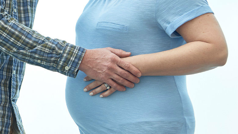 Couple holding mother's belly