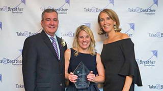 Debbie McGrath receiving her award