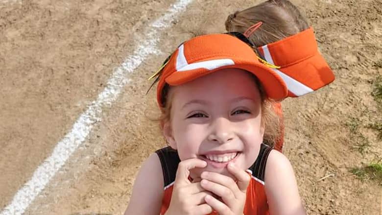 Audrey in her softball uniform