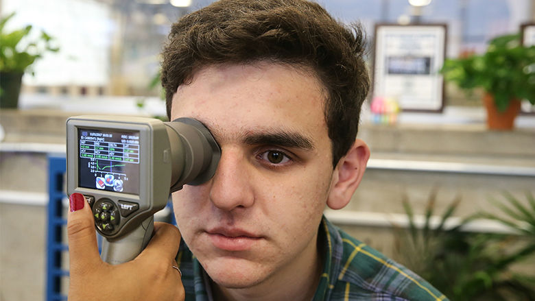 Male patient receiving checkup to right eye