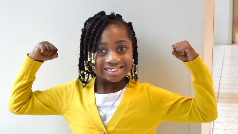 Young girl flexing her muscles