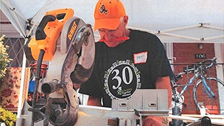 Patrick cutting wood in his shop