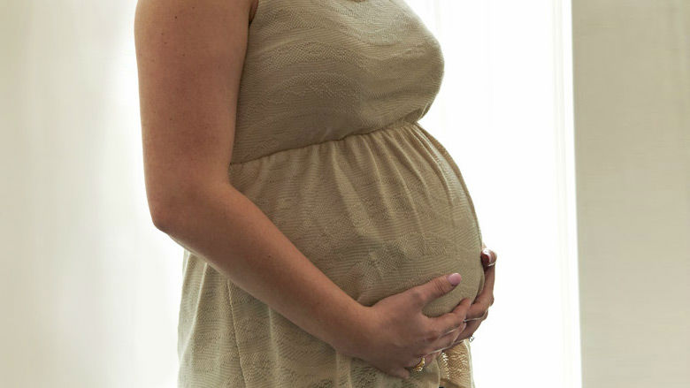 Mother holding pregnant stomach