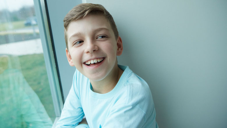 boy hospital patient smiling in window