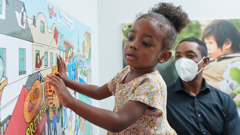 Little girl looking at the wall art