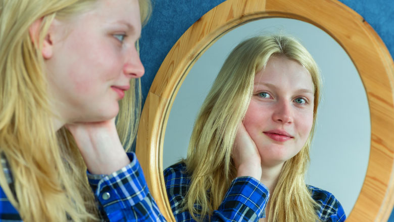 Girl smiling in mirror