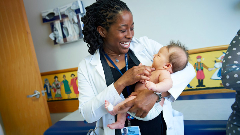 Nurse practitioner holding a baby