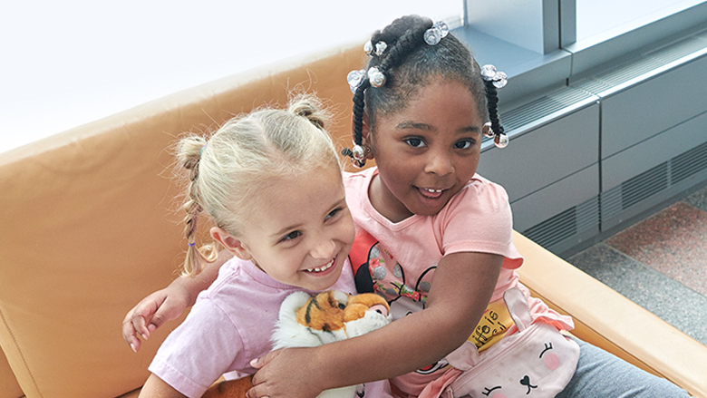 Preschool girls hugging