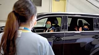 Family in car awaiting COVID-19 testing