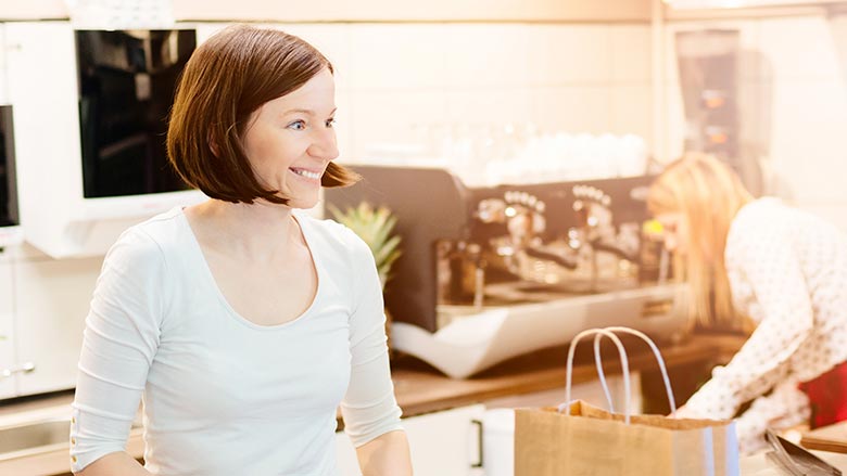 Woman at register of food store