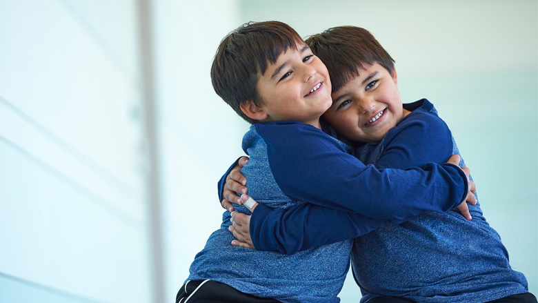 Siblings hugging