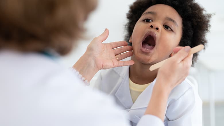 Kid getting his throat checked