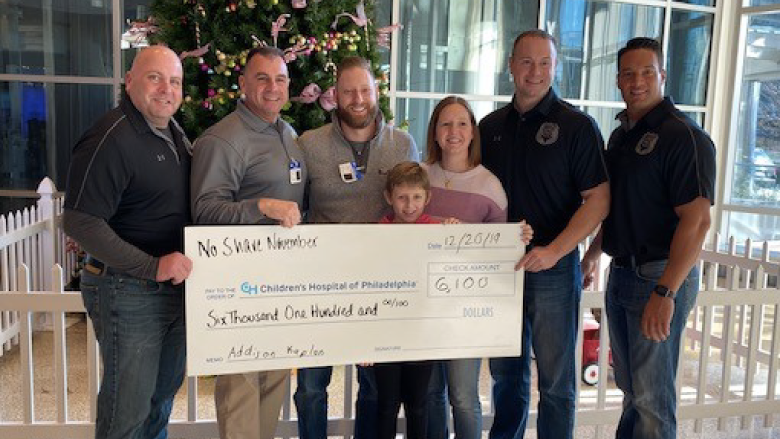 Addison and Marlboro police department members with fundraiser check