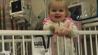 Emma in a hospital crib