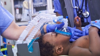 Anesthesia team administering general anesthesia through mask