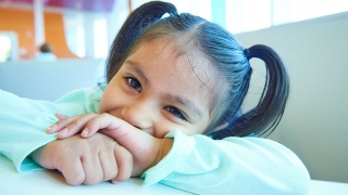 Young girl with pigtails, shy smiling