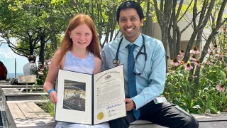 Emma proudly shows Arunjot Singh, MD, MPH, the proclamation she received from the Pennsylvania House of Representatives, recognizing her for her celiac awareness efforts.