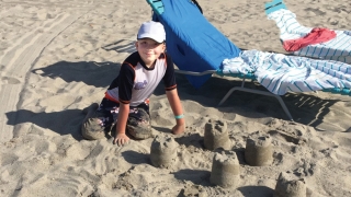 Connor playing in the sand at the beach