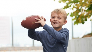 Carter holding a football