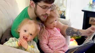 Dad reading book to the Delaney twins