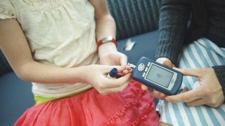 girl testing blood sugar