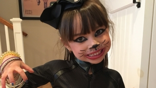 Ella smiling in a halloween costume