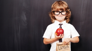 boy holding lunch bag