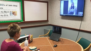 Nurse and family engaged in tele-education session