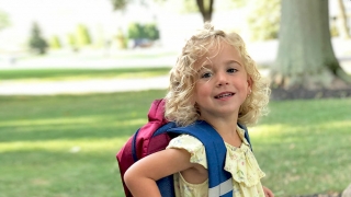 Maeve with her school backpack
