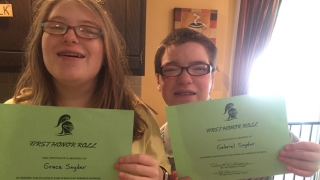 Grace and Gabriel holding up Honor Roll Awards