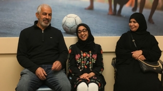 Hamada with her parents sitting and smiling